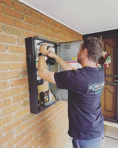 Down Under Electrical and Air electrician servicing a residential switchboard in Narre Warren